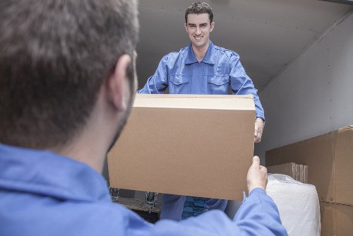 Packed boxes and furniture staged for a local business relocation