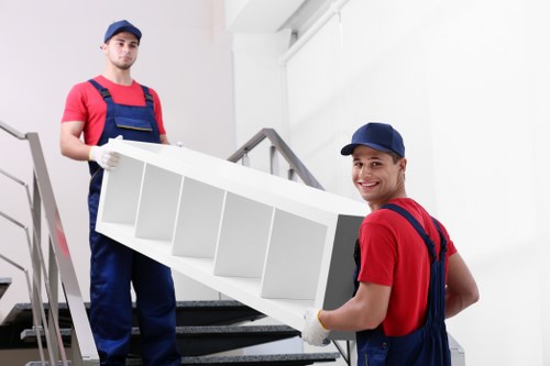 Removal team handling large furniture in a Notting Hill property