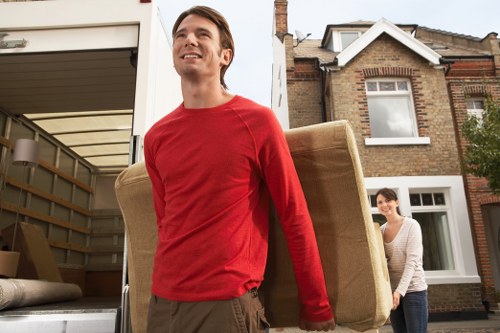 Moving vehicle positioned for a commercial move on a narrow Notting Hill street