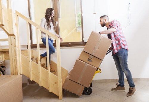 Packed office boxes and equipment prepared for a business relocation in Notting Hill