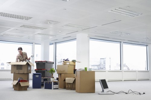 Trained movers loading furniture into a moving truck in West London