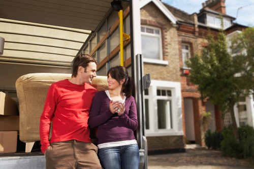 House moving team handling boxes and furniture in a suburban street